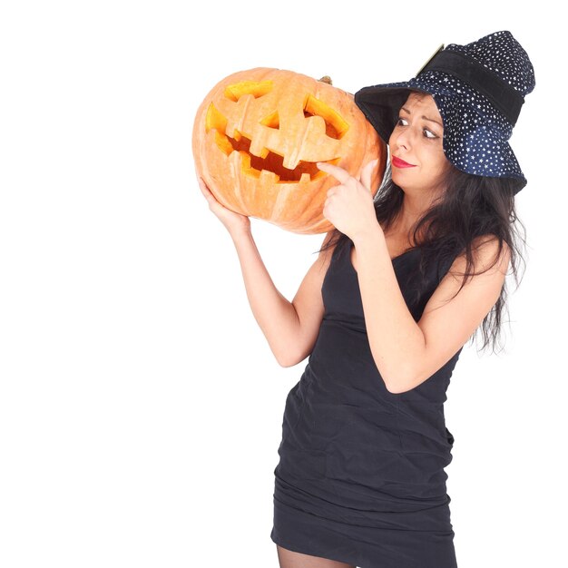 Beautiful young witch with the Halloween pumpkin