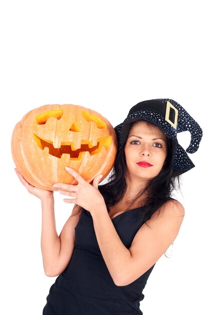 Beautiful young witch with the Halloween pumpkin