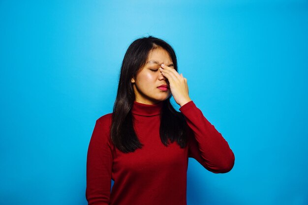 Beautiful young woman against blue background