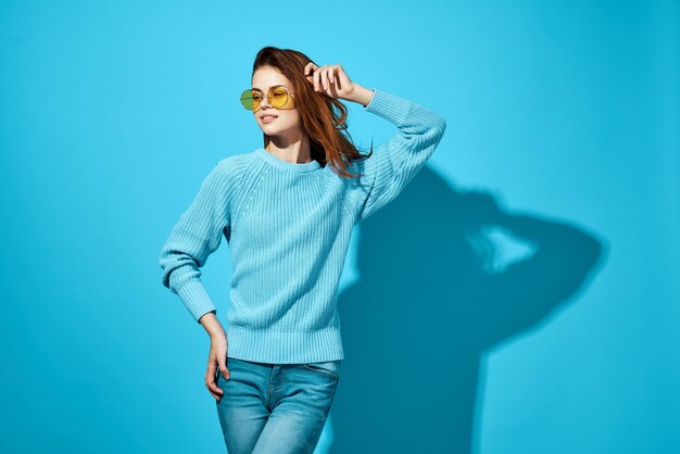 Beautiful young woman against blue background