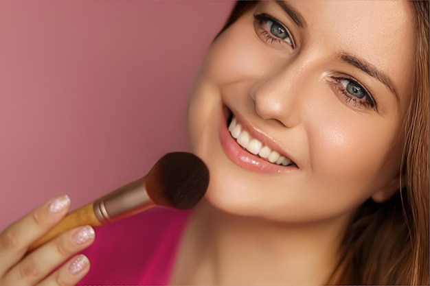 Beautiful young woman applying cosmetic powder product with makeup bamboo brush beauty makeup and skincare cosmetics model face portrait on pink background