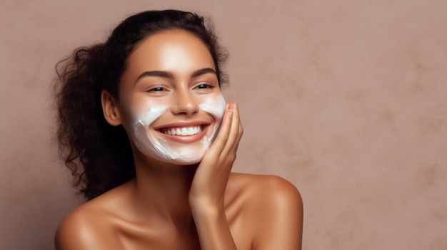 Beautiful young woman applying facial mask on her face Skin care and treatment spa natural beauty and cosmetology concept over beige background with copy space