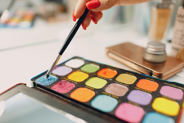 Beautiful young woman applying makeup beauty visage brush