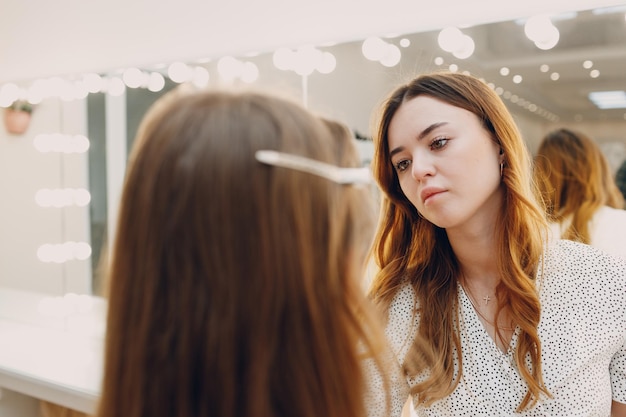 Beautiful young woman applying makeup beauty visage brush