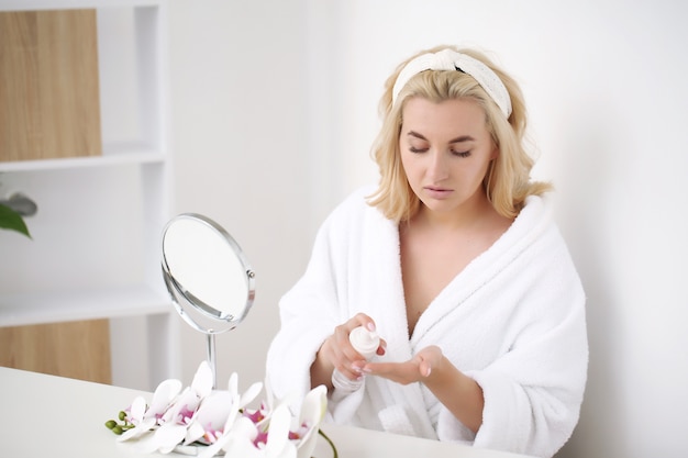 Beautiful young woman in a bathrobe