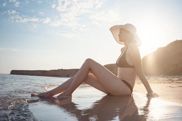 Beautiful Young Woman At Beach Wearing Hat