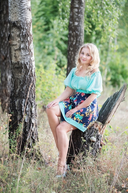 Beautiful young woman in the birch forest