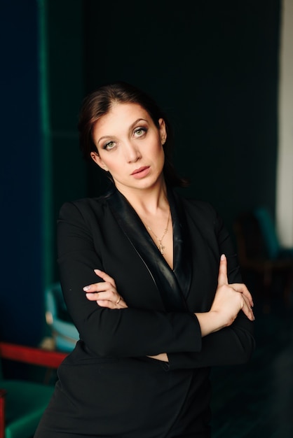 Beautiful young woman in black jacket at home