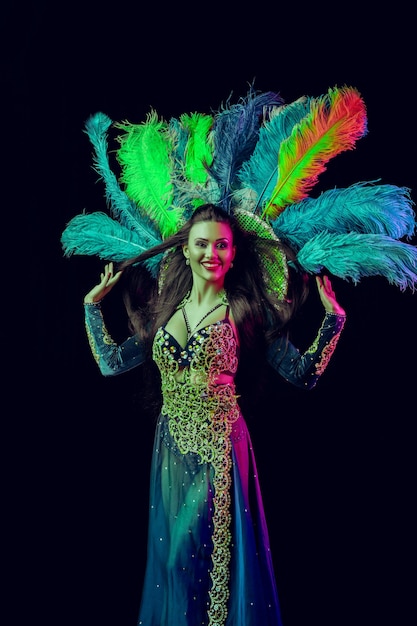 Beautiful young woman in carnival peacock costume Beauty model woman at party over holiday