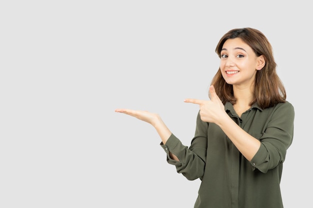 Beautiful young woman in casual outfit showing her opened palms