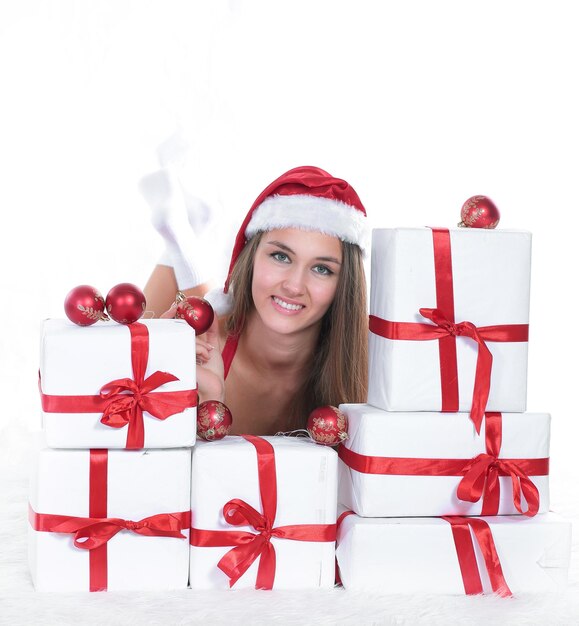 Beautiful young woman in christmas suit with a stack of christm