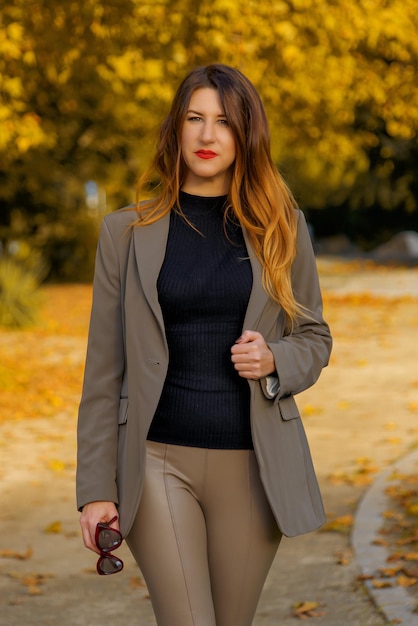 Beautiful young woman in the city in autumn