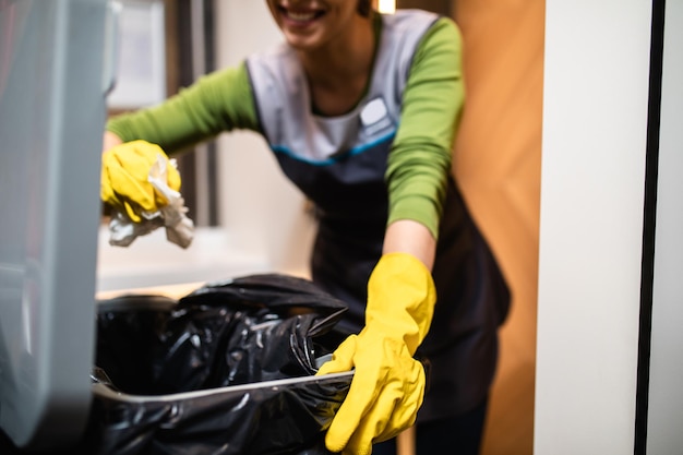 Beautiful young woman cleaning at shopping mall. Cleaning concept.