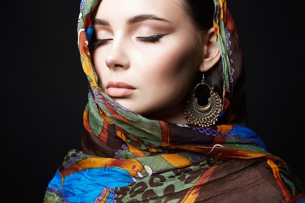 Beautiful young woman in color veil and jewelry beauty girl in colorful hijab