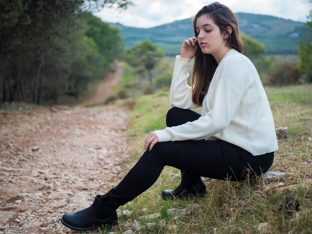 Beautiful young woman in contact with nature