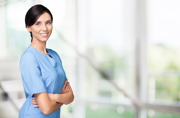 Beautiful young woman doctor smiling in work uniform