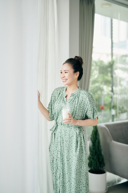 Beautiful young woman drinking milk