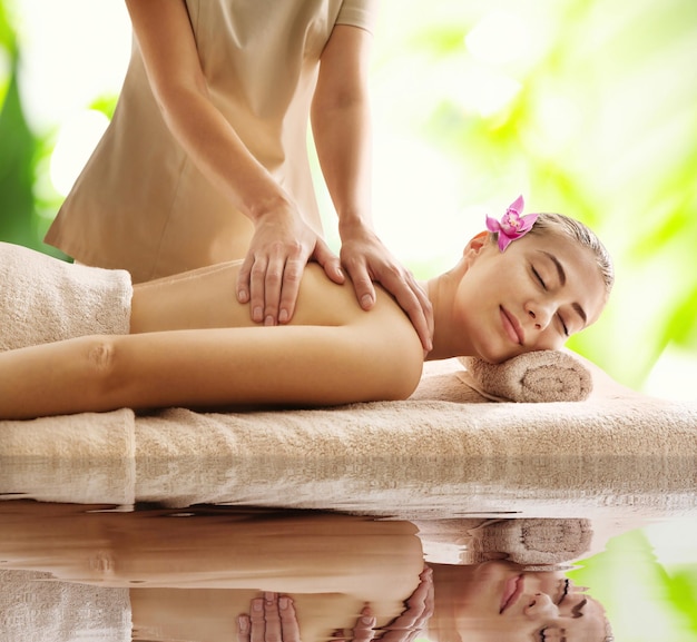 Beautiful young woman enjoying massage Spa treatment