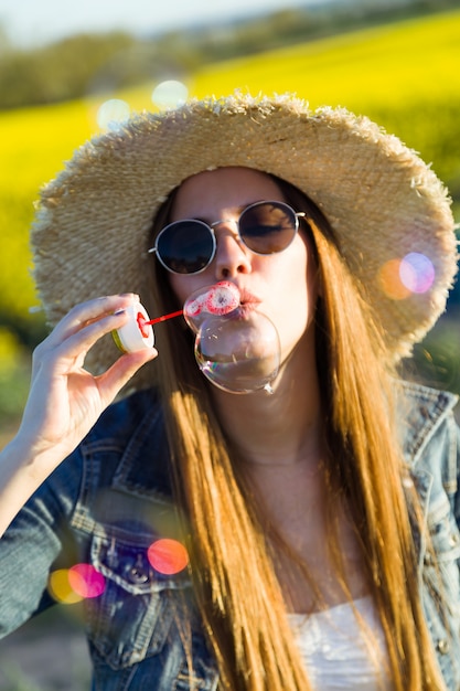 Beautiful young woman enjoying spring in a field.