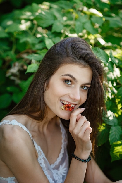 Beautiful young woman gardening outside in summer nature. deeds and the concept of a summer outhouse, a green garden and freedom