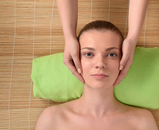 Beautiful young woman getting relaxing head massage