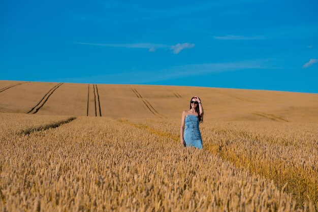 beautiful young woman in golden wheat field