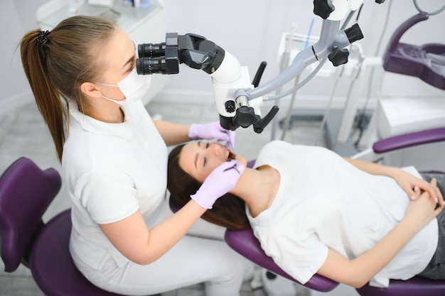 Beautiful young woman having dental treatment at dentist's office