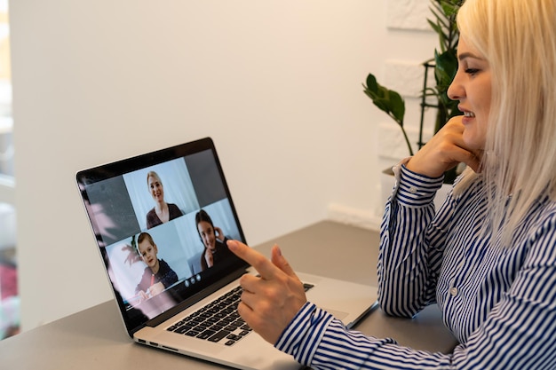 Beautiful young woman having video conference call via computer. Call Meeting. Home office. Stay at home and work from home concept during Coronavirus pandemic