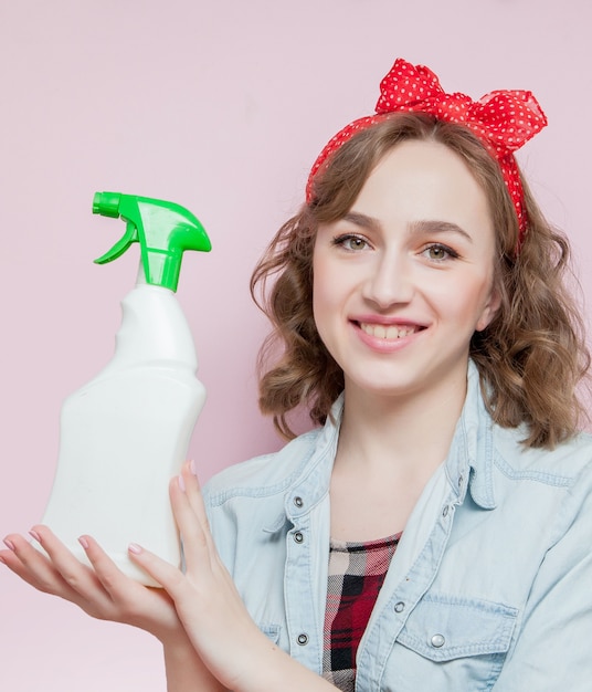 Beautiful young woman holding a bottle