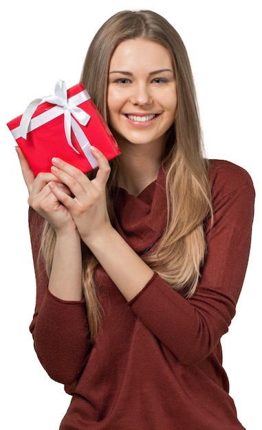 Beautiful young woman holding christmas gift on white background