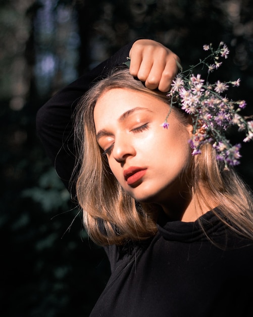 Beautiful young woman holding flower