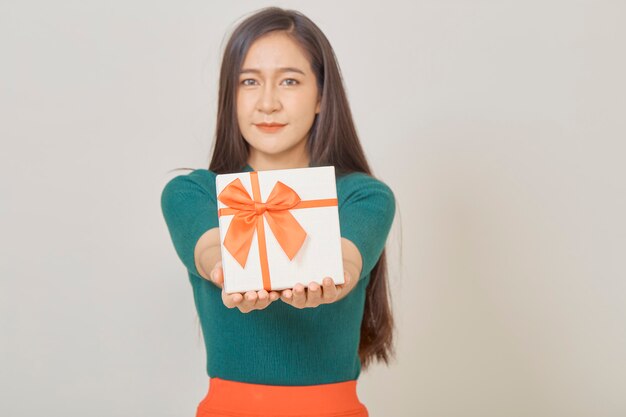 Beautiful young woman holding a gift