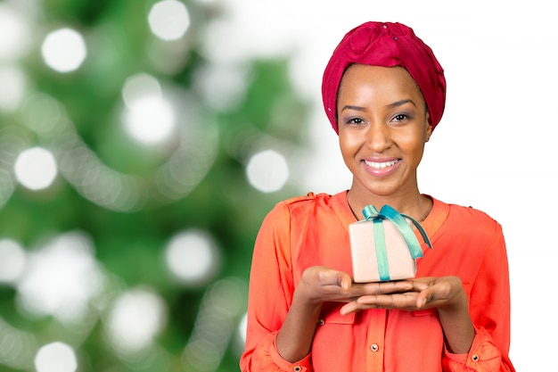 Beautiful young woman holding a gift