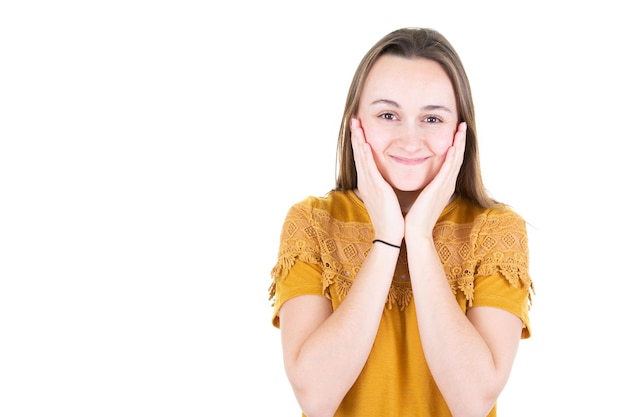 Beautiful young woman holding hands under chin cheeks with copy space