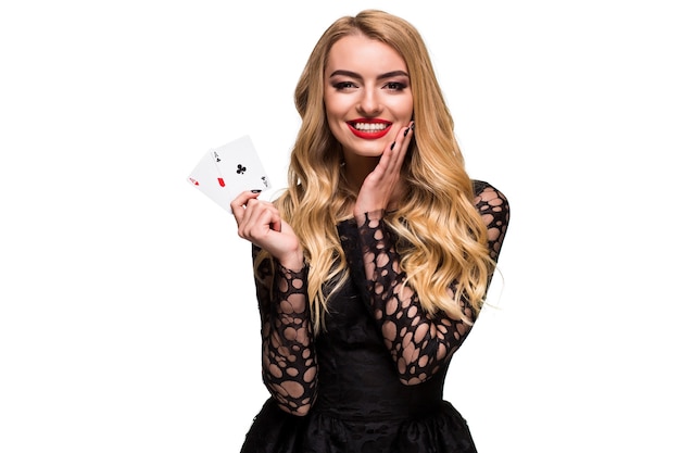 Beautiful young woman holding two ace of cards in her hand isolated on black background