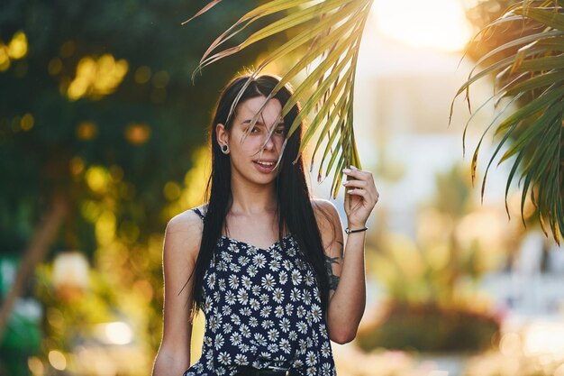 Beautiful young woman is outdoors at sunny daytime Concept of vacation