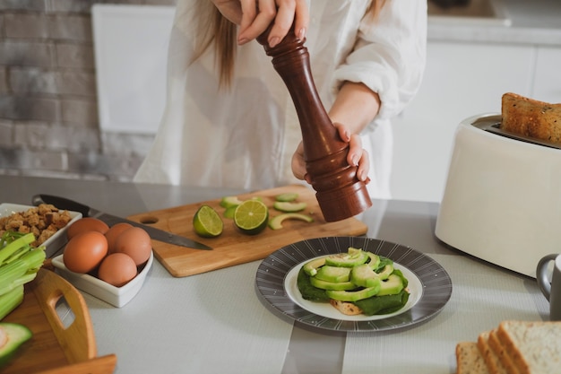 Beautiful young woman in the kitchen at home prepares healthy food