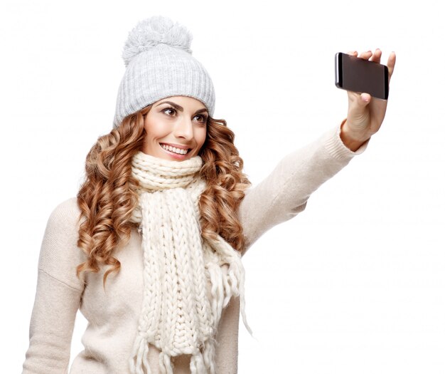 Beautiful young woman in knitted wool sweater smiling