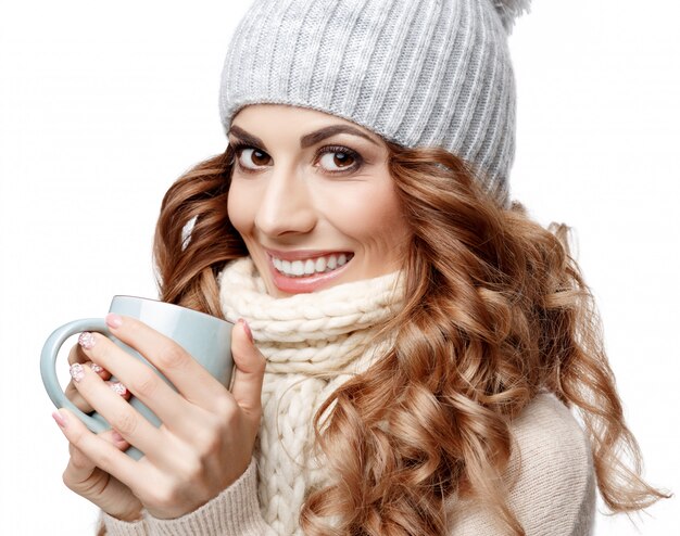 Beautiful young woman in knitted wool sweater smiling