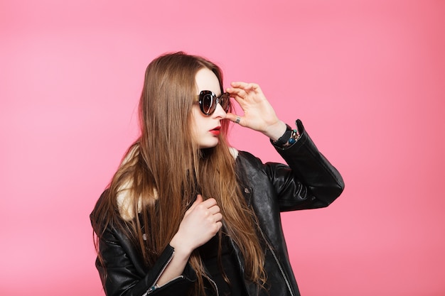 Beautiful young woman in leather jacket and glasses