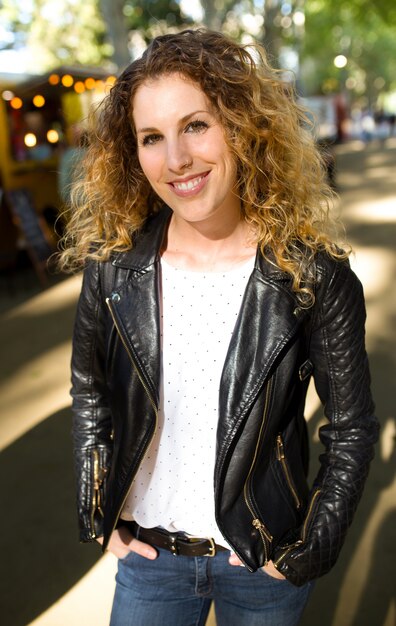 Beautiful young woman looking at camera in the street.