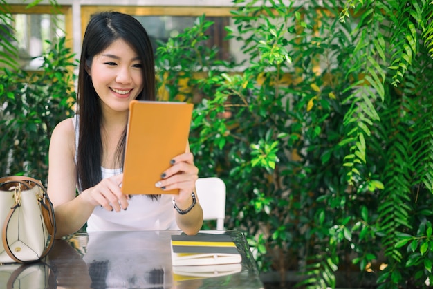 beautiful young woman looking at camera with joyful and charming smile, woman concept