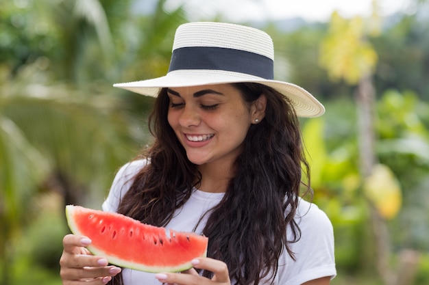 Beautiful Young Woman Looking At Slice Of Watermelon