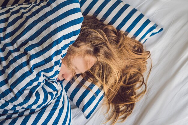 Beautiful young woman lying down in bed and sleeping. do not get enough sleep concept.