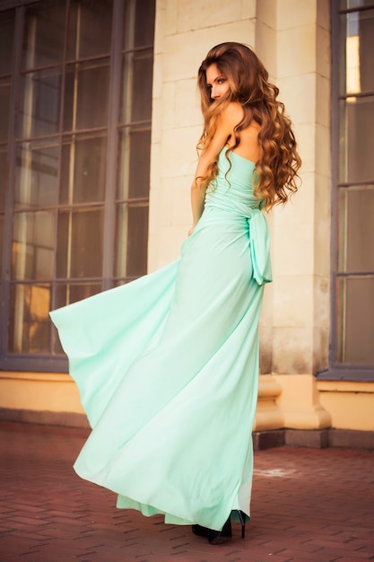 Beautiful young woman in a mint elegant dress