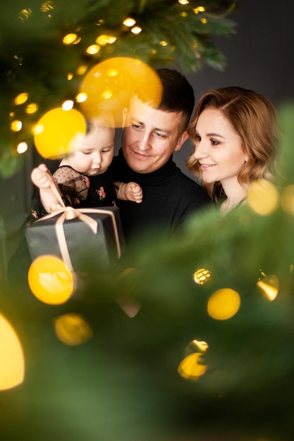 Beautiful young woman mother of little baby on dark background