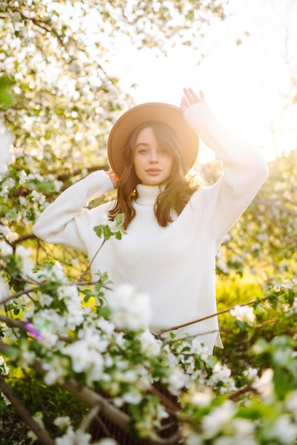 Beautiful young woman near blooming spring tree Youth love romantic concept