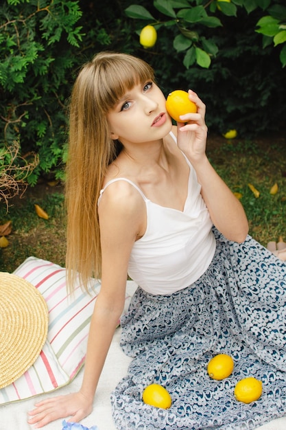 Beautiful young woman on a picnic in the garden