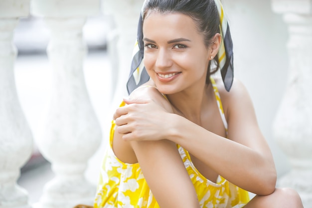 Beautiful young woman portrait. Female outdoors on summertime. Beauty near the fountain. Urban stylish lady.