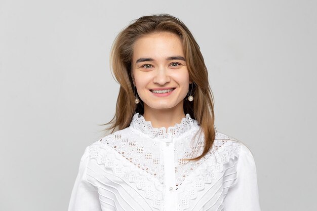 Beautiful young woman portrait Studio shot isolated on gray background